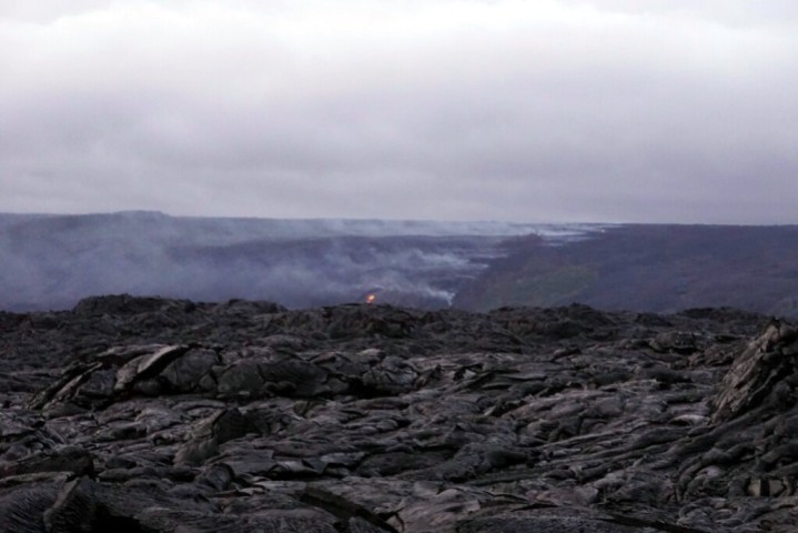 Lava flowing downhill to the ocean